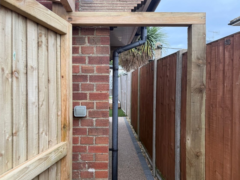 Timber framed entranceway with overhead beam