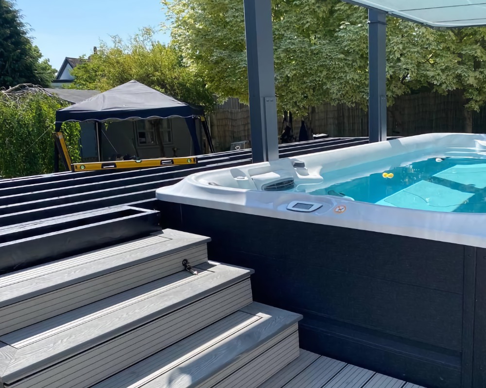 Luxury swim spa set into modern decking area in backyard
