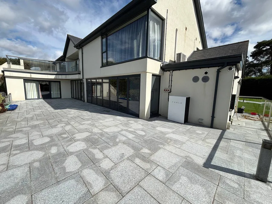 Rendered house with new glazing and a porcelain patio
